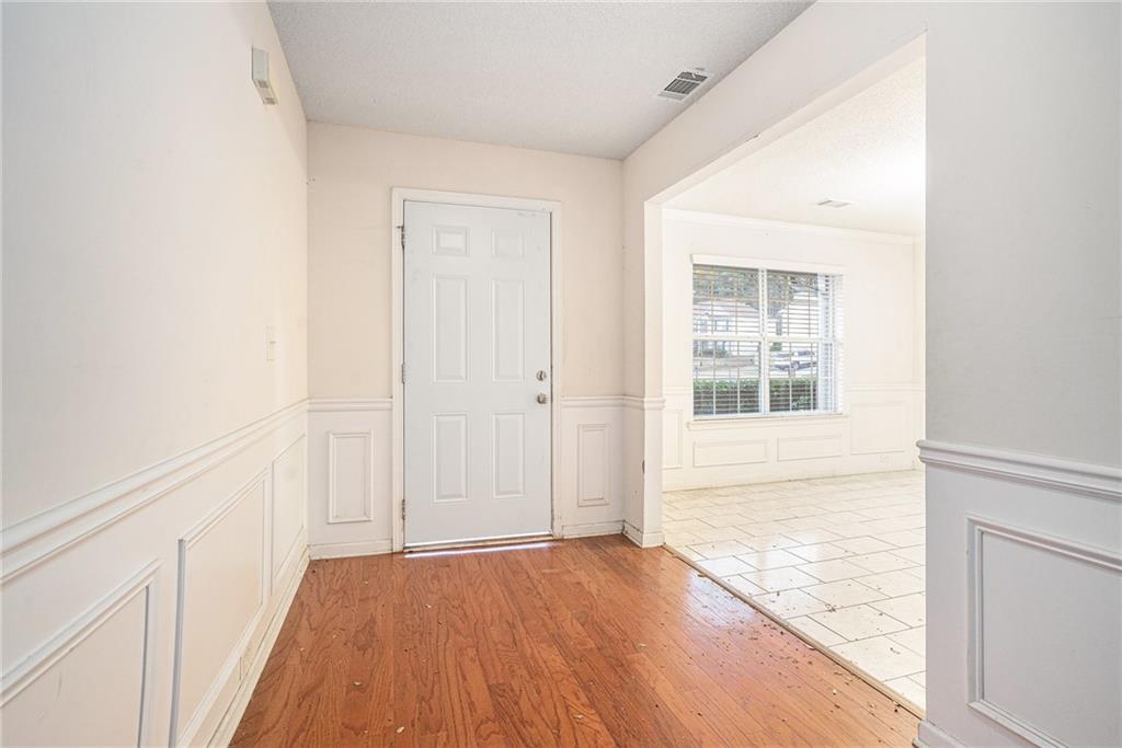 1915 Cornerstone Pass Way Conyers, GA 30012 - Photo 3 of 25 an empty room with wooden floor and windows