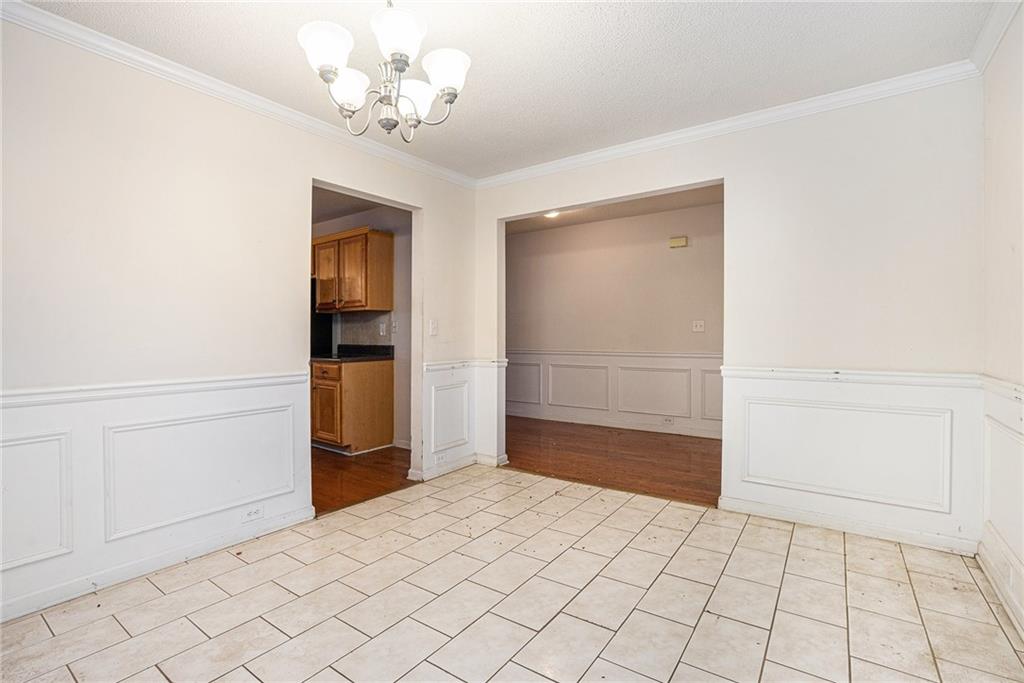 1915 Cornerstone Pass Way Conyers, GA 30012 - Photo 5 of 25 a view of a livingroom with a chandelier fan and windows