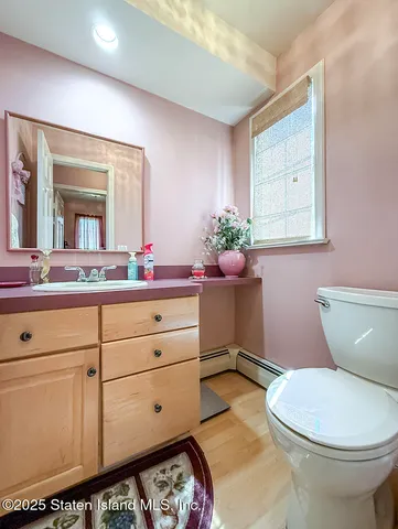 a bathroom with a sink mirror and toilet