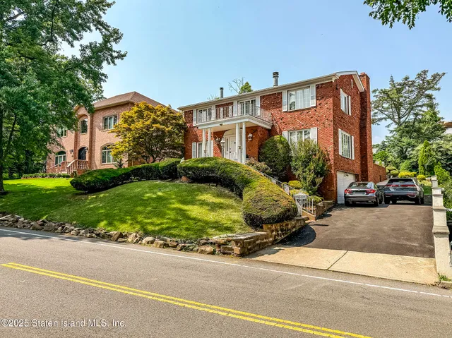 a front view of a house with a garden and plants