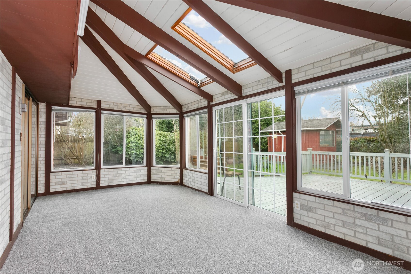 7416 25th Street West Tacoma, WA 98466 - Photo 22 of 39 a view of an empty room with wooden floor and a balcony