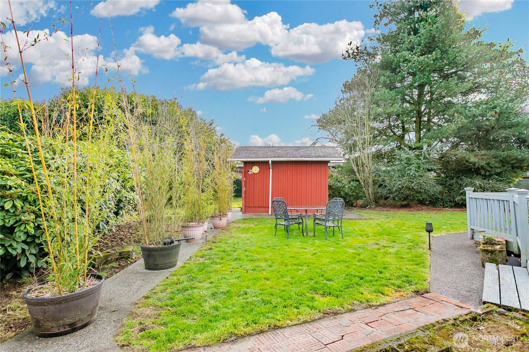7416 25th Street West Tacoma, WA 98466 - Photo 35 of 39 a backyard of a house with table and chairs potted plants