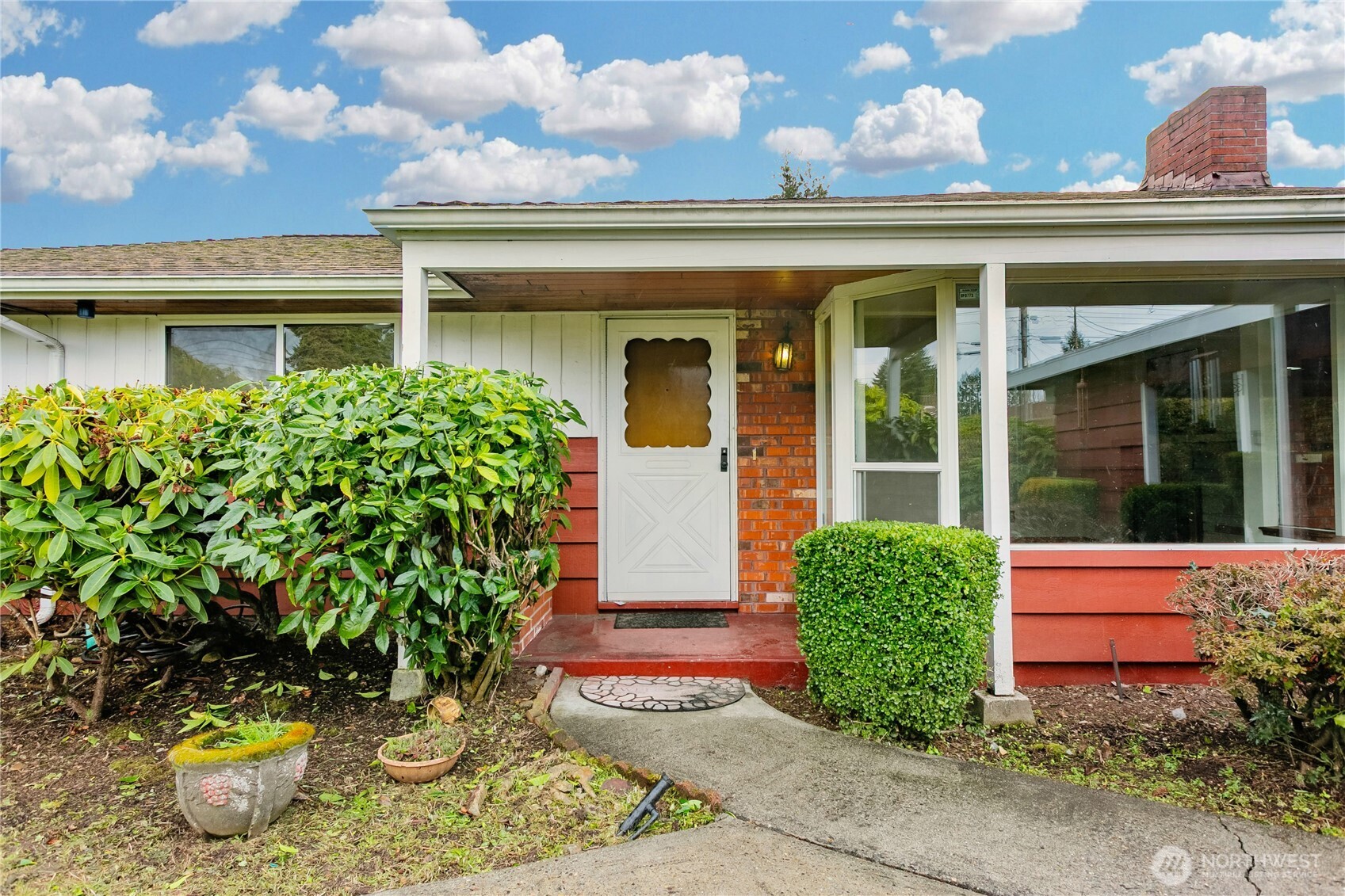 7416 25th Street West Tacoma, WA 98466 - Photo 5 of 39 front view of a brick house with potted plants