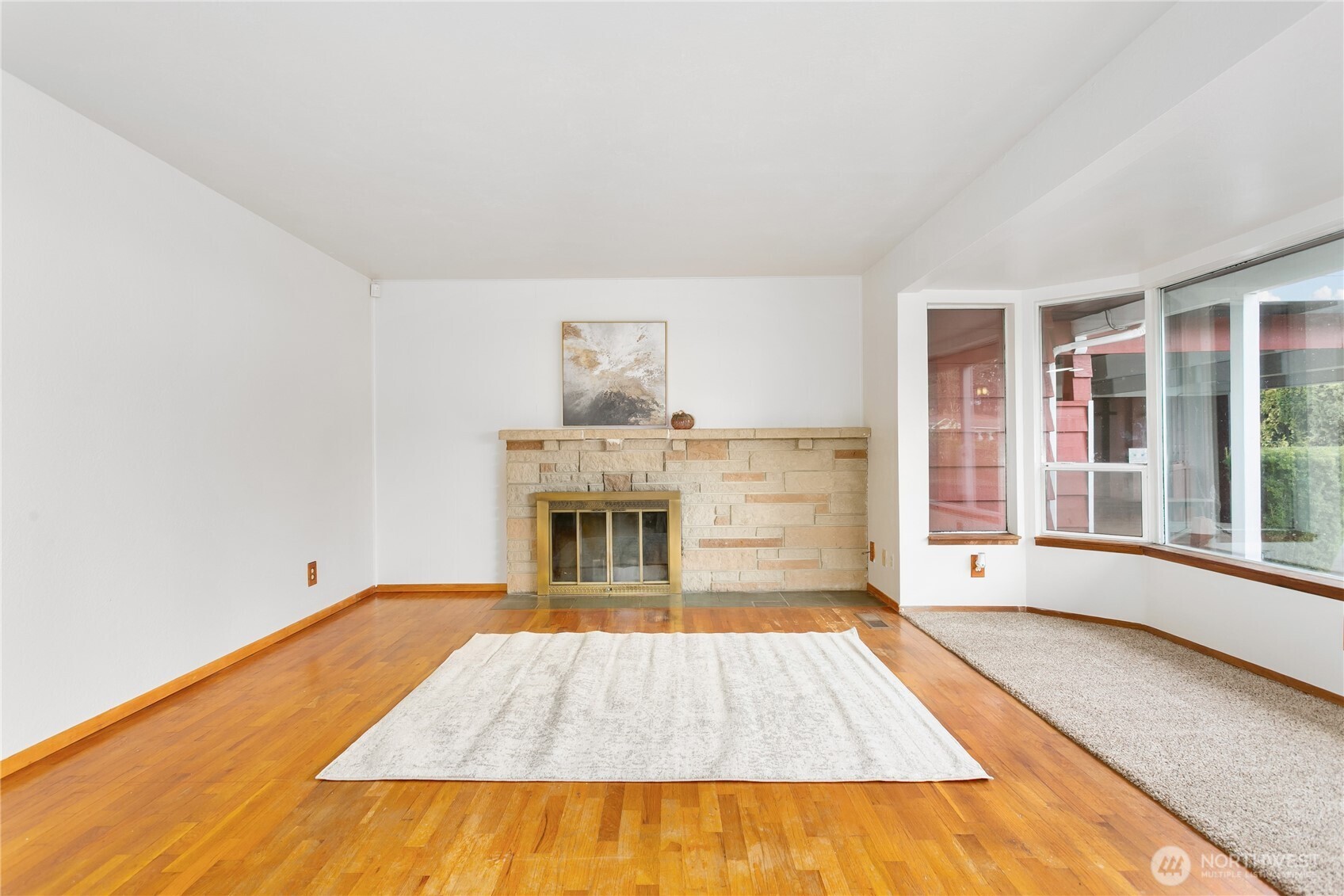 7416 25th Street West Tacoma, WA 98466 - Photo 7 of 39 a view of empty room with wooden floor and fireplace