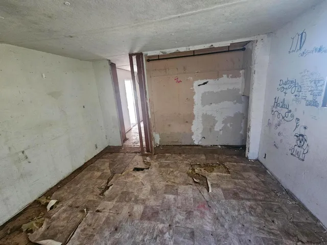 a view of a hallway with wooden shelves
