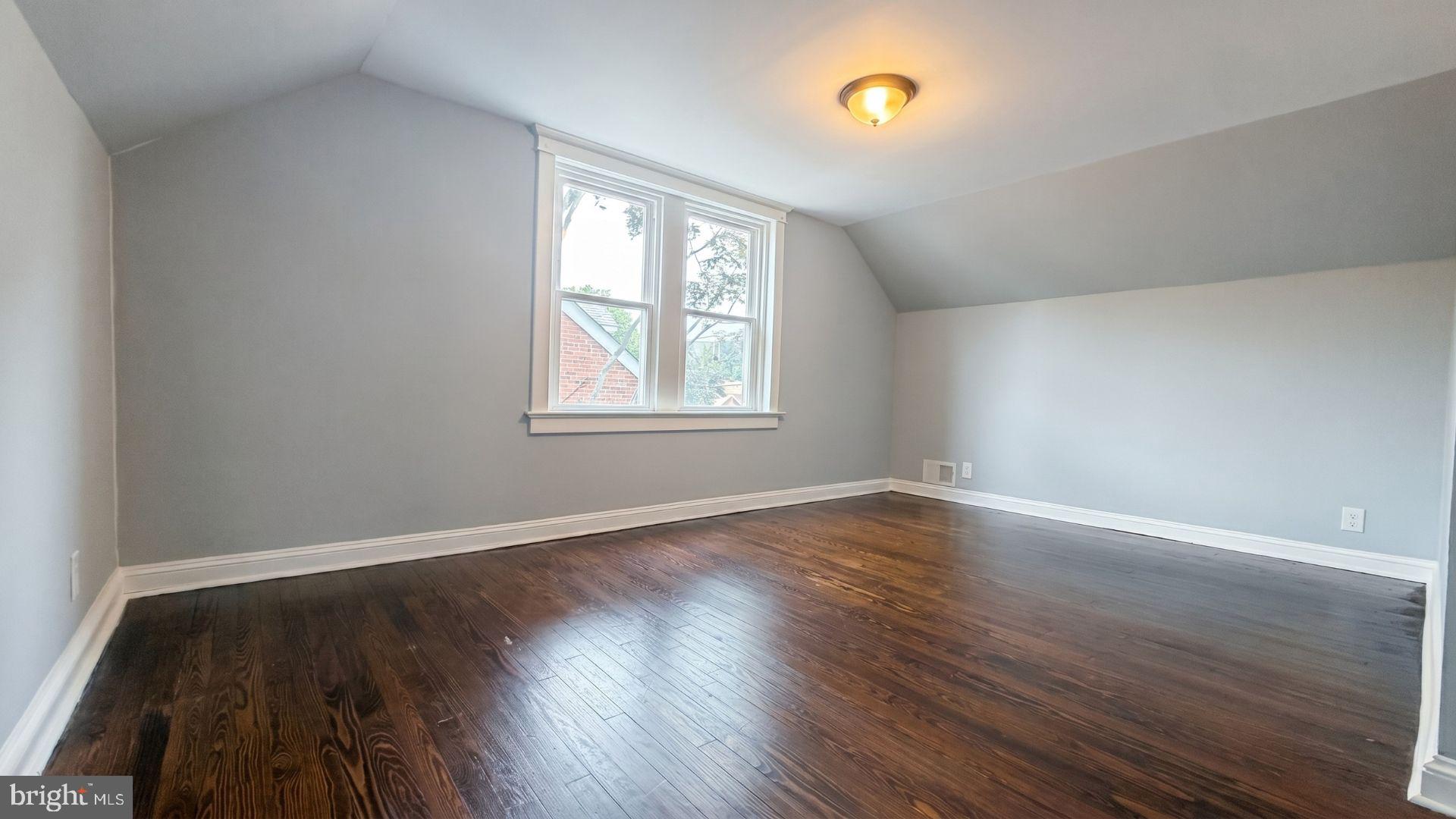 154 Andrew Street Hamilton, NJ 08610 - Photo 23 of 29 an empty room with wooden floor and windows