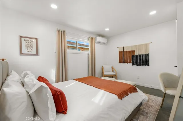 a bedroom with a bed and a lamp