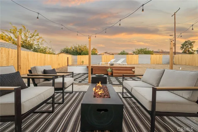 a outdoor patio with dining table and chairs