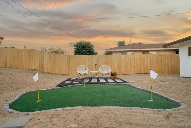 an aerial view of a house with a garden and mountain view