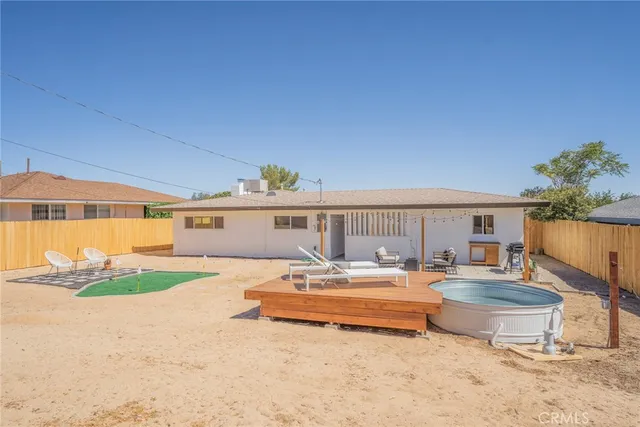 a view of a patio with couches chairs with wooden floor