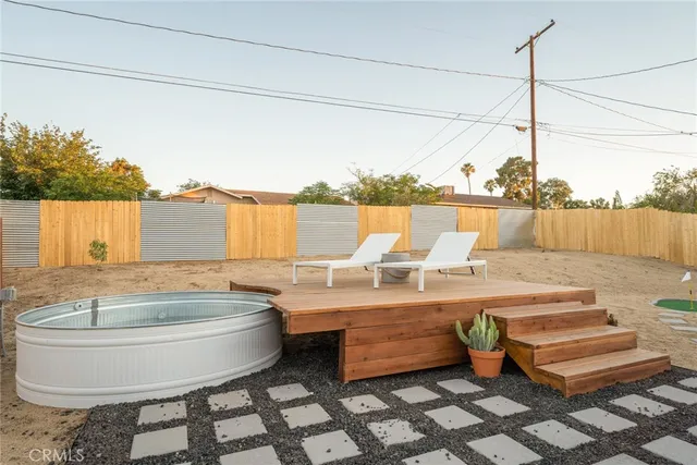 a view of a house with wooden roof and sitting space