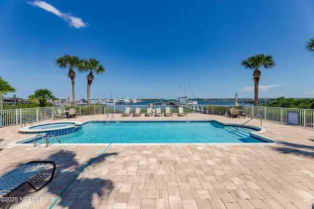 a view of a lake with boats and trees in the background