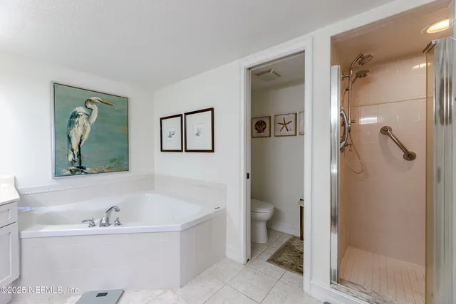 a bathroom with a granite countertop sink mirror and toilet