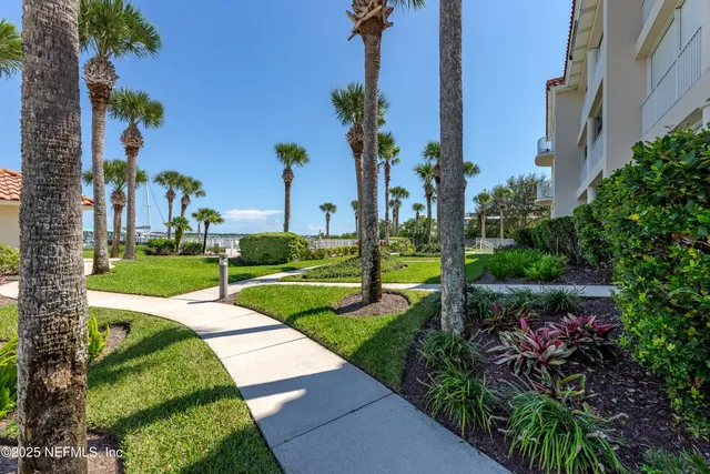 a living room with furniture a flat screen tv and a floor to ceiling window