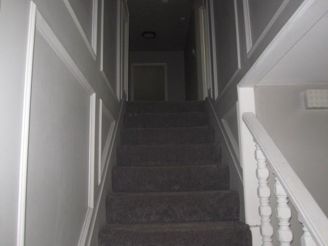 2801 Pyramid Circle Denison, TX 75020 - Photo 11 of 18 a view of staircase with white walls and door