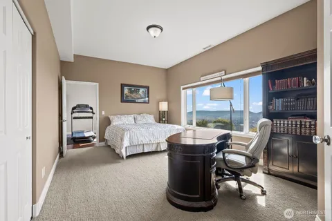 a living room with furniture a flat screen tv and a window