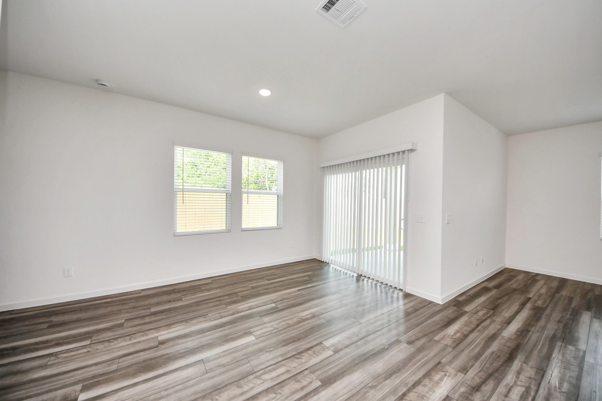 10303 Rose Mar Drive, Unit B Rosharon, TX 77583 - Photo 9 of 49 wooden floor in an empty room with a window