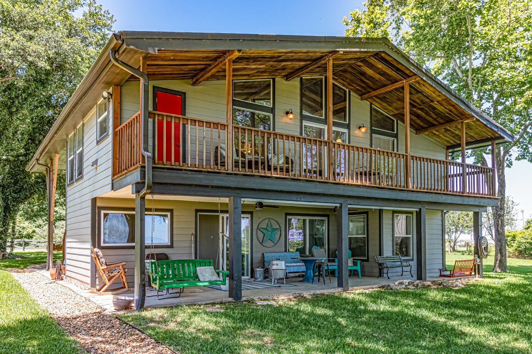 480 Johnson Road Coldspring, TX 77331 - Photo 2 of 49 Balcony upstairs and a patio downstairs for relaxation
