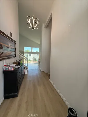a view of a livingroom with wooden floor and a window
