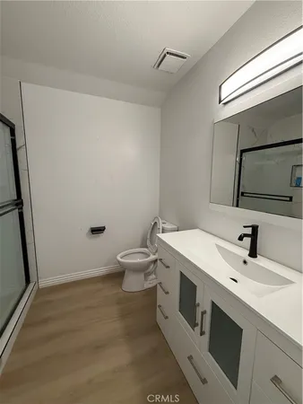 a bathroom with a glass shower door