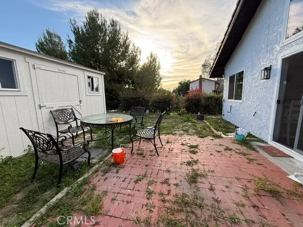 a view of a house with backyard and sitting area