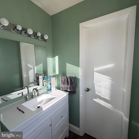 a bathroom with a sink vanity and mirror