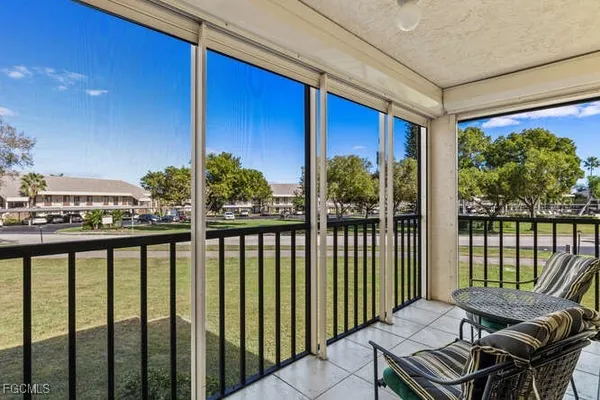 a view of a balcony with chairs