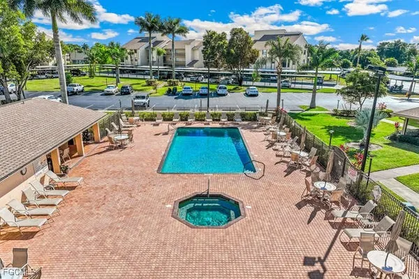 a view of a swimming pool with a patio and a garden