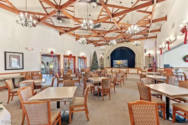 a view of a dining room with furniture chandelier and a rug