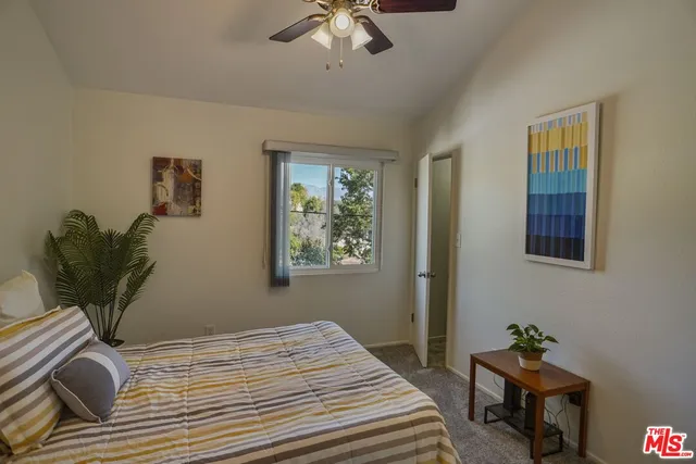 a bedroom that has a bed and a chandelier