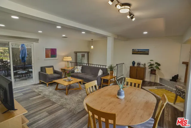 a living room with lots of furniture and view of kitchen