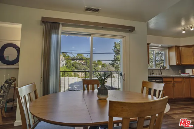 a view of a dining room with furniture window and wooden floor