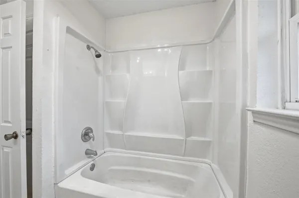 a bathroom with a tub and a shower
