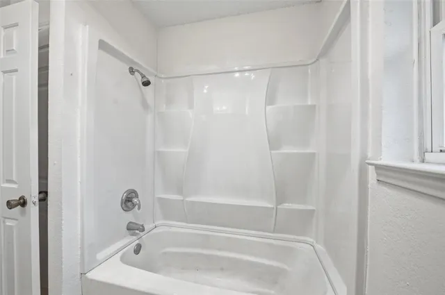 a bathroom with a tub and a shower