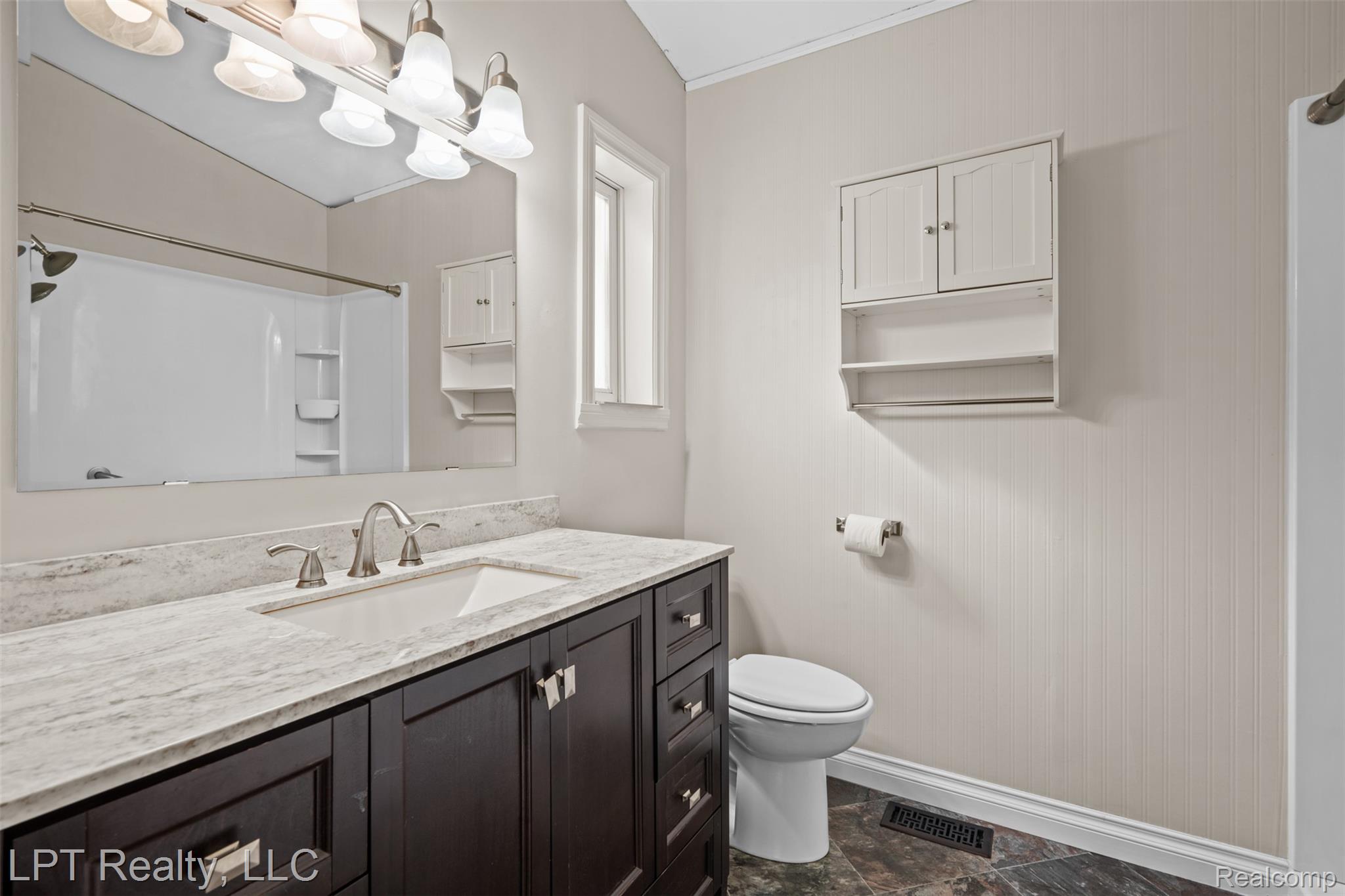 6271 East Potter Road Davison, MI 48423 - Photo 15 of 41 Full bathroom with vanity and a shower