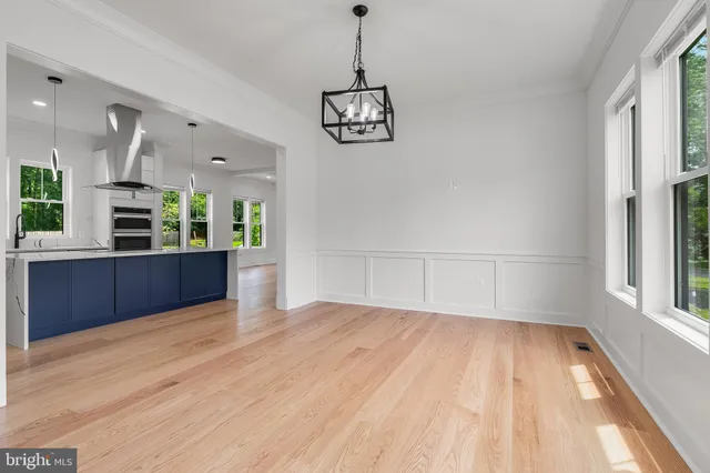 a view of a room with wooden floor and windows