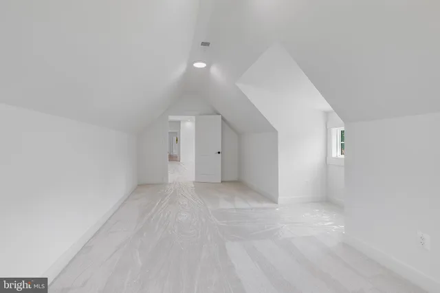 a bathroom with a bathtub a sink a mirror and a window