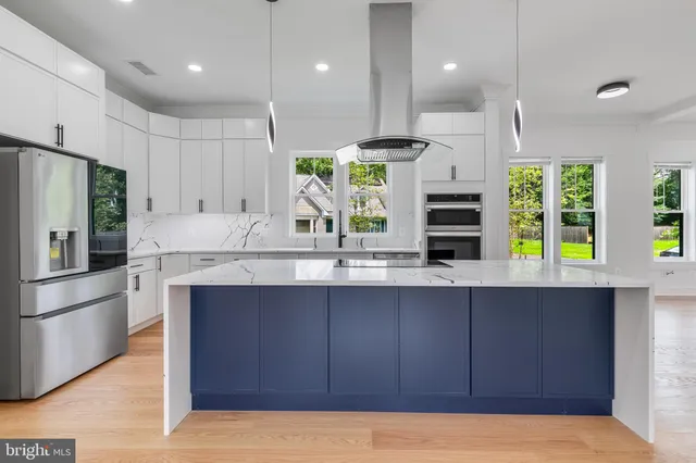 a kitchen with stainless steel appliances granite countertop a sink a stove and a refrigerator