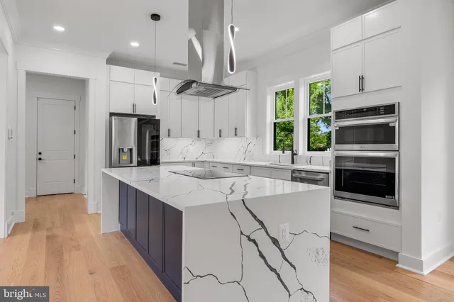 a kitchen with a sink stainless steel appliances and cabinets