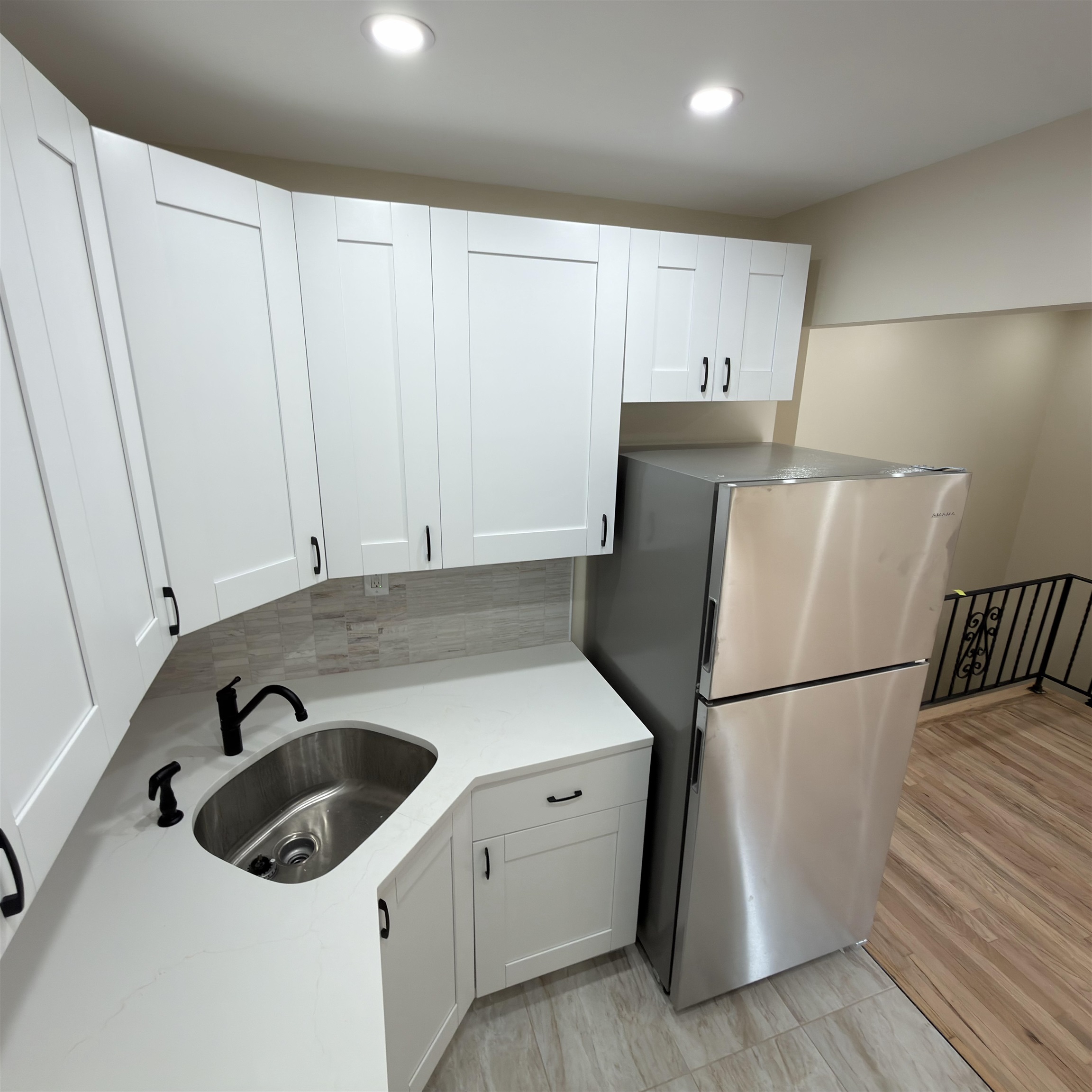 a kitchen with a refrigerator and a sink