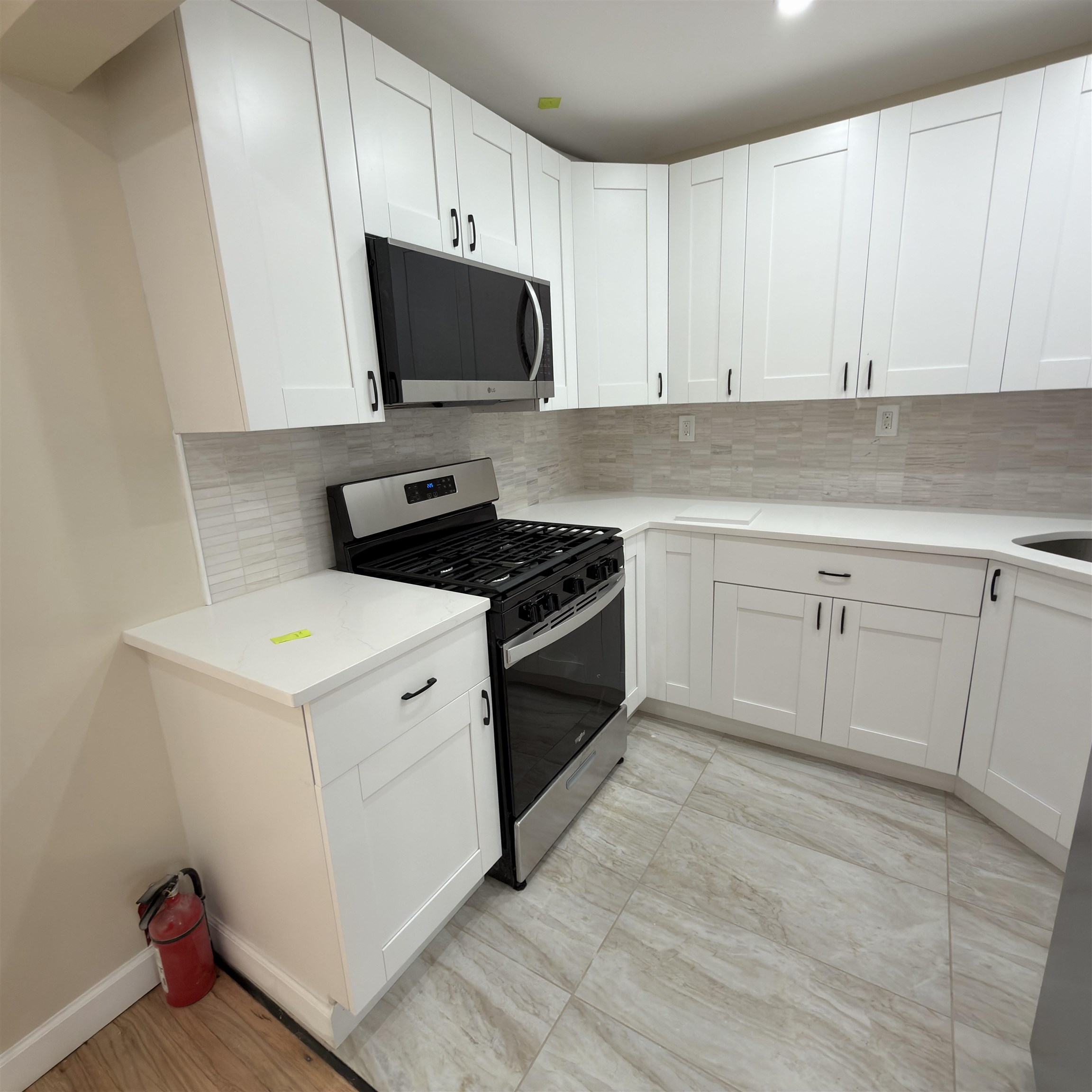 810 23rd Street, Unit 3 Union City, NJ 07087 - Photo 12 of 12 a kitchen with white cabinets and white appliances