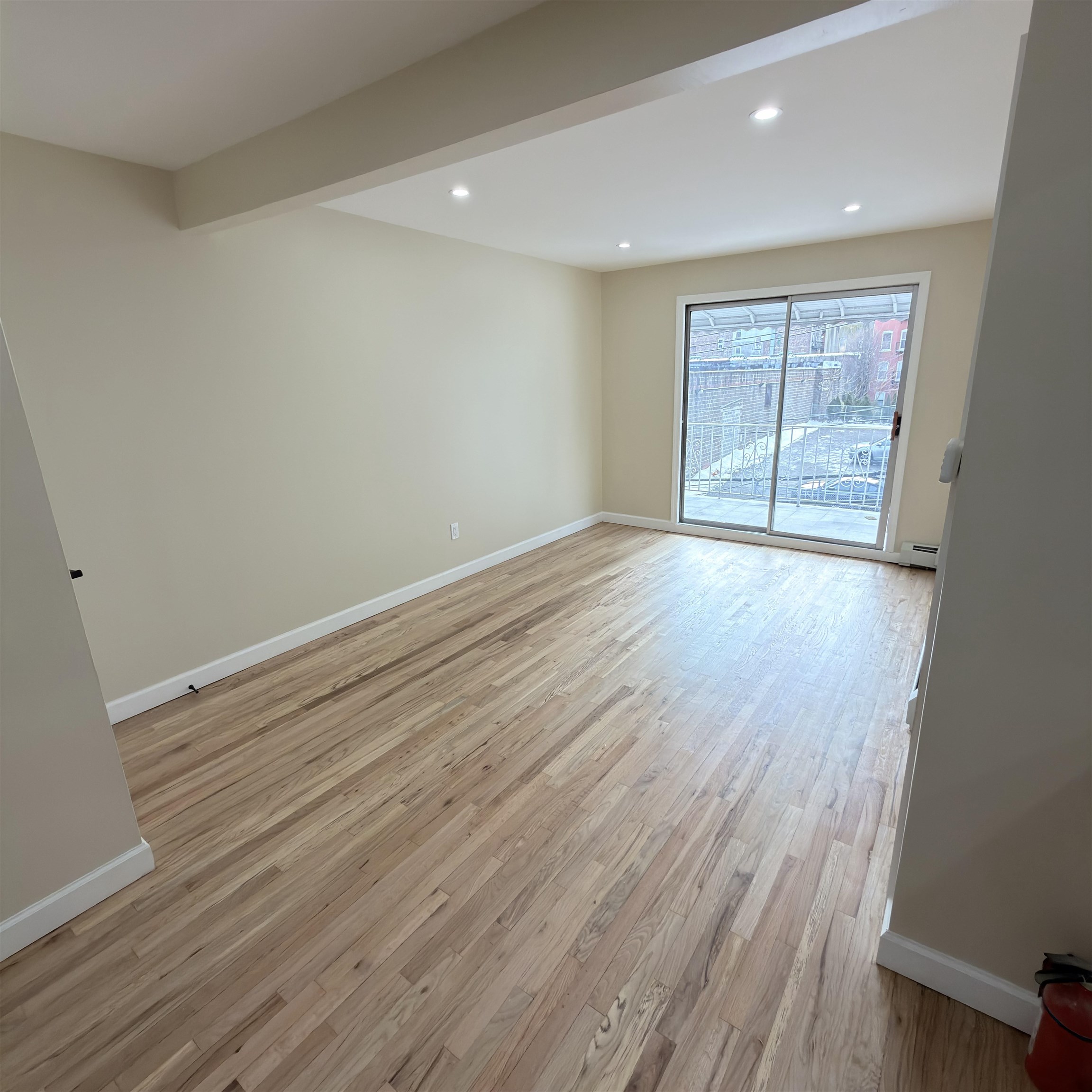810 23rd Street, Unit 3 Union City, NJ 07087 - Photo 10 of 12 wooden floor in an empty room with a window