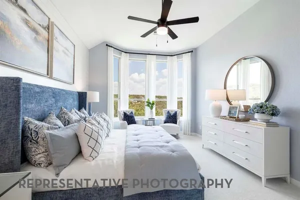 a bedroom with a large bed and a dresser