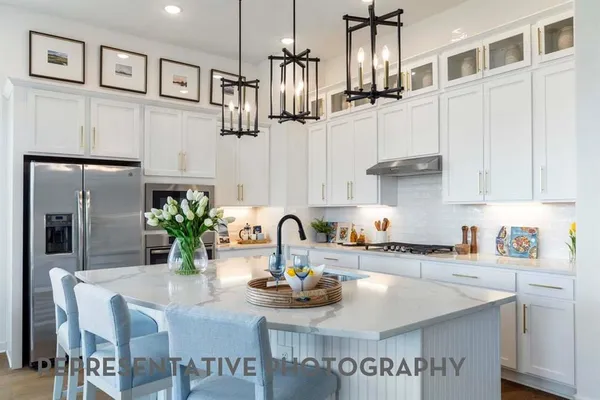 a kitchen with stainless steel appliances kitchen island granite countertop a sink and cabinets