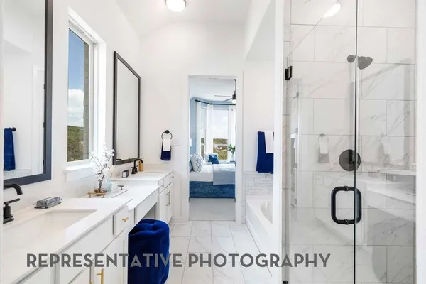 a bathroom with a sink double vanity and shower