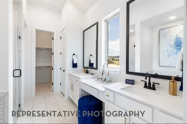 a spacious bathroom with a double vanity sink a mirror and a shower
