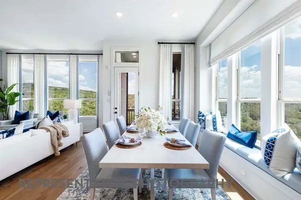 a view of a dining room with furniture window and wooden floor