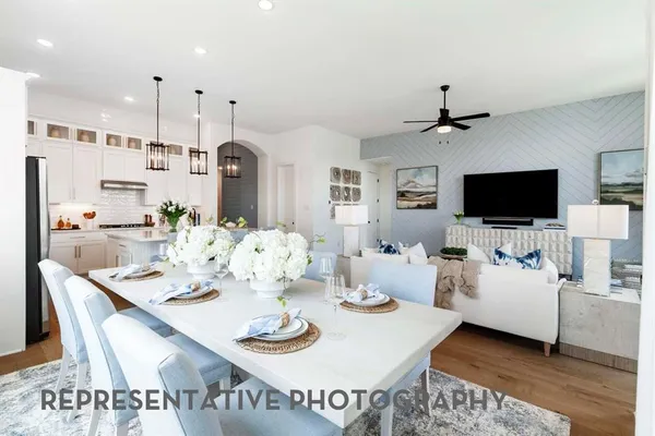 a open dining room with furniture and wooden floor
