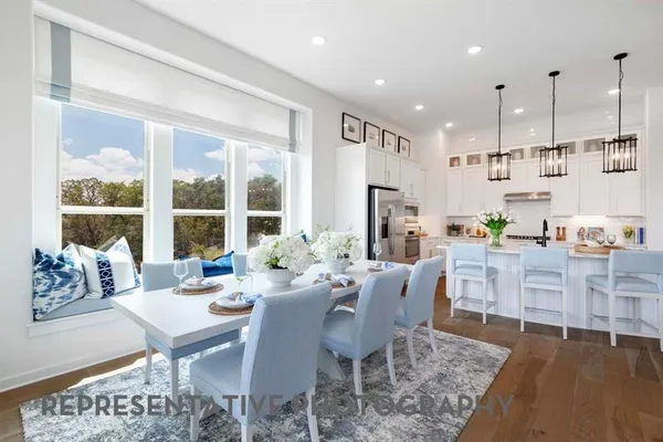 a view of a dining room with furniture large windows and wooden floor