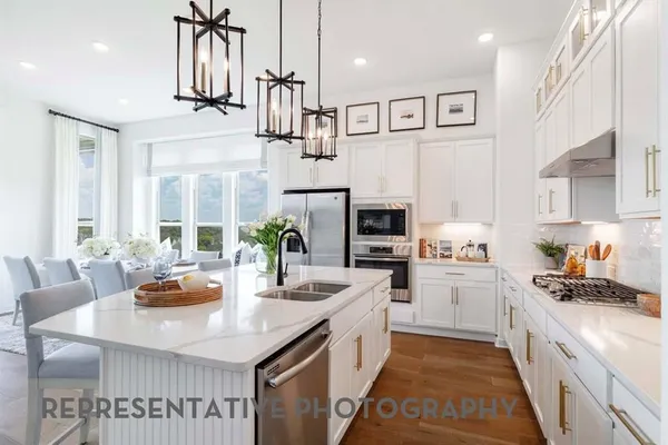 a kitchen with stainless steel appliances kitchen island granite countertop a sink and cabinets